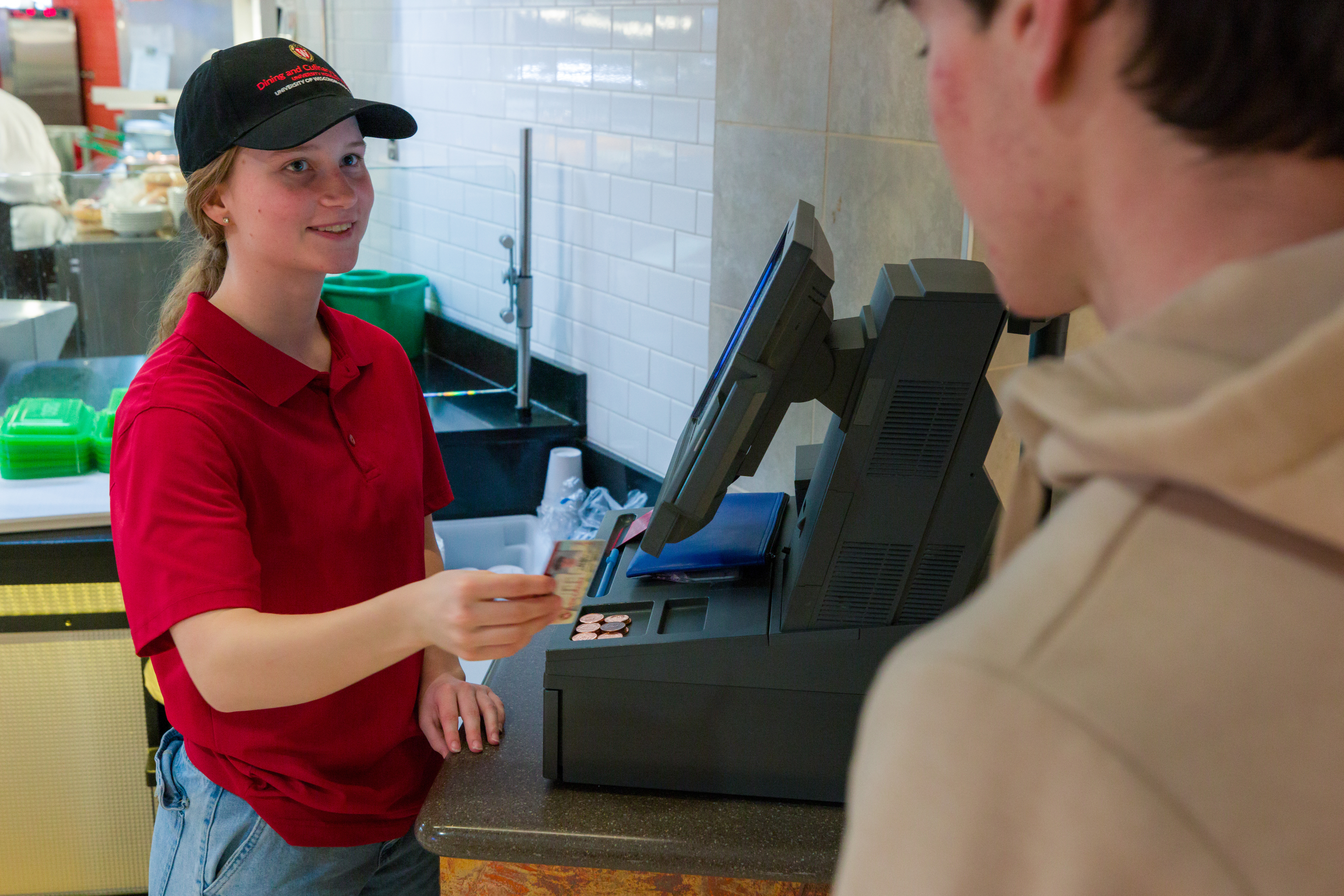 A Dining student employee redeeming a student's meal swipe 
