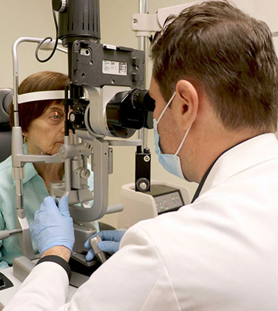 doctor examines a woman's eyes