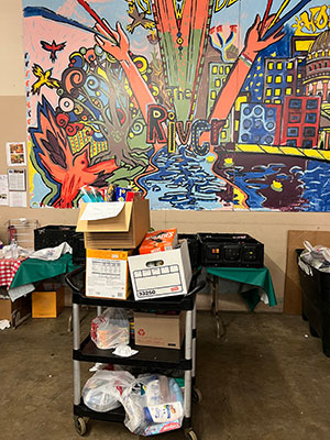 box of supplies in front of a mural