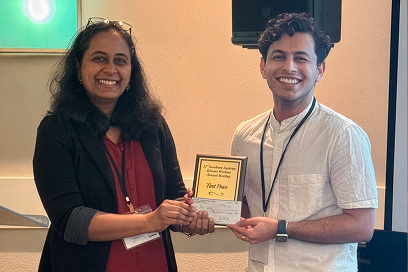 Graduat student Amit Sharma receiving an award at a conference.