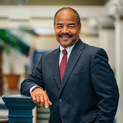 Dean Eric Wilcots wearing suit.
