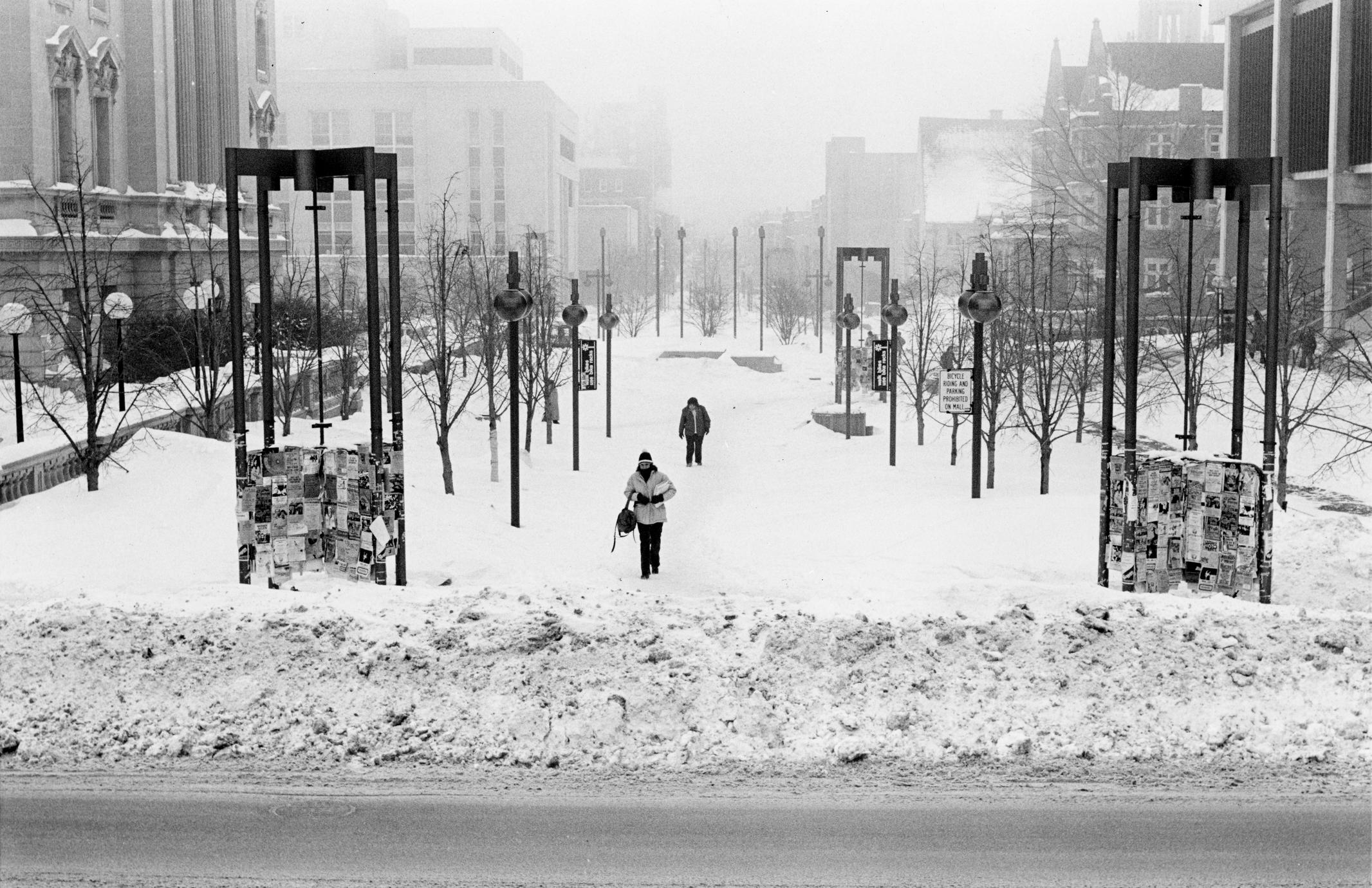 Photo of students walking down State Street in the snow. (ca. 1979)