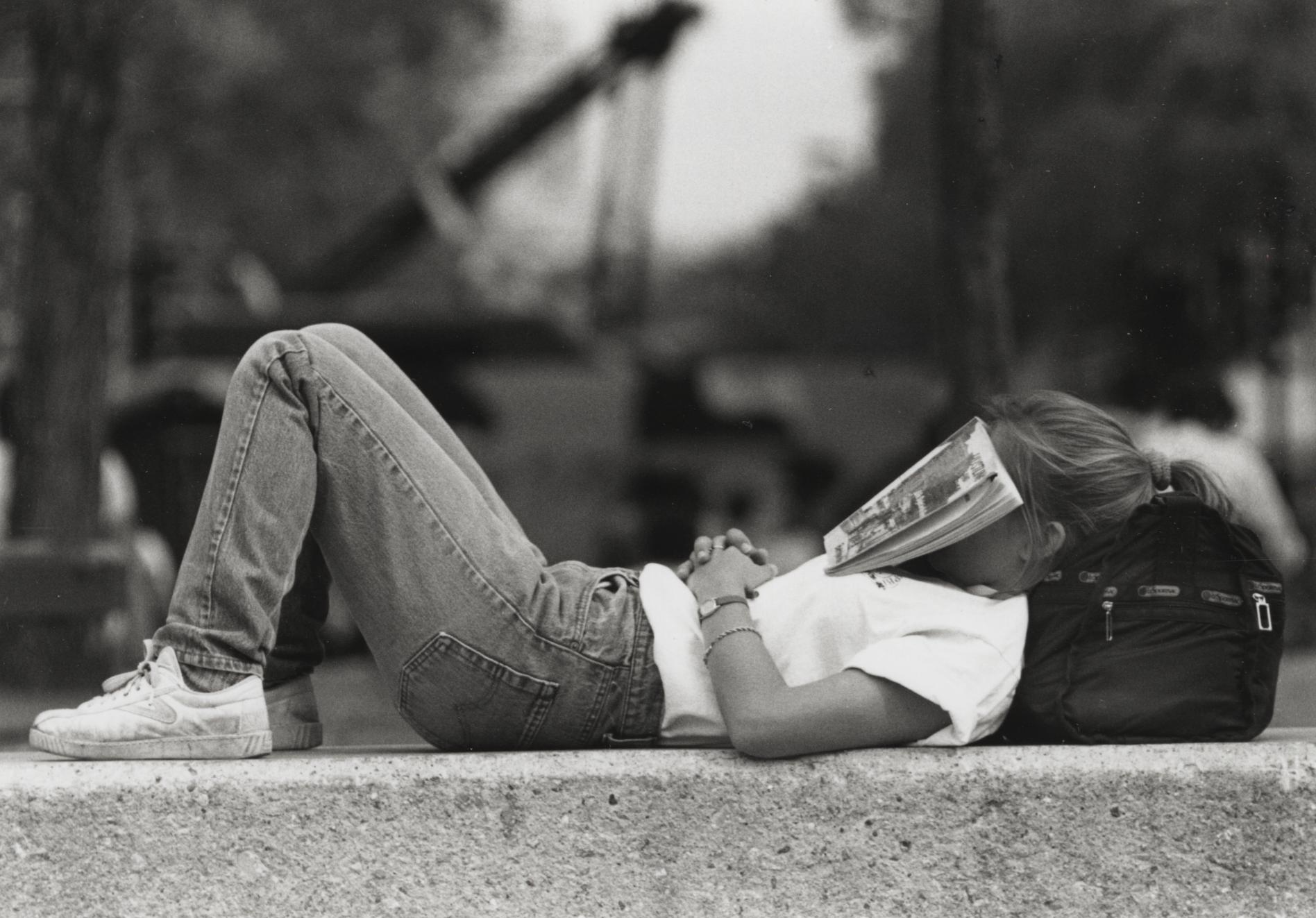 Student resting at Library Mall UW Digital Collections photo