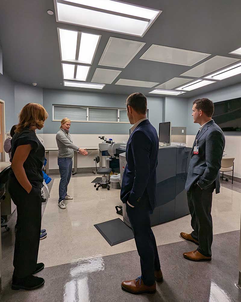 four people looking at surgical equipment