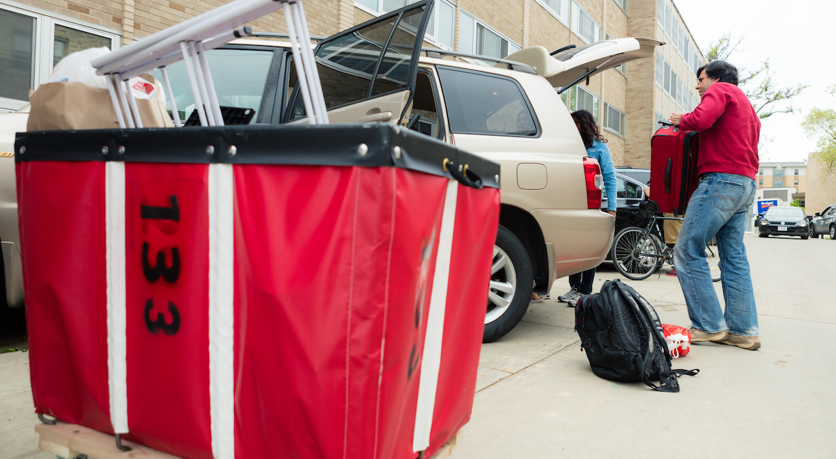 People packing a car during move-out