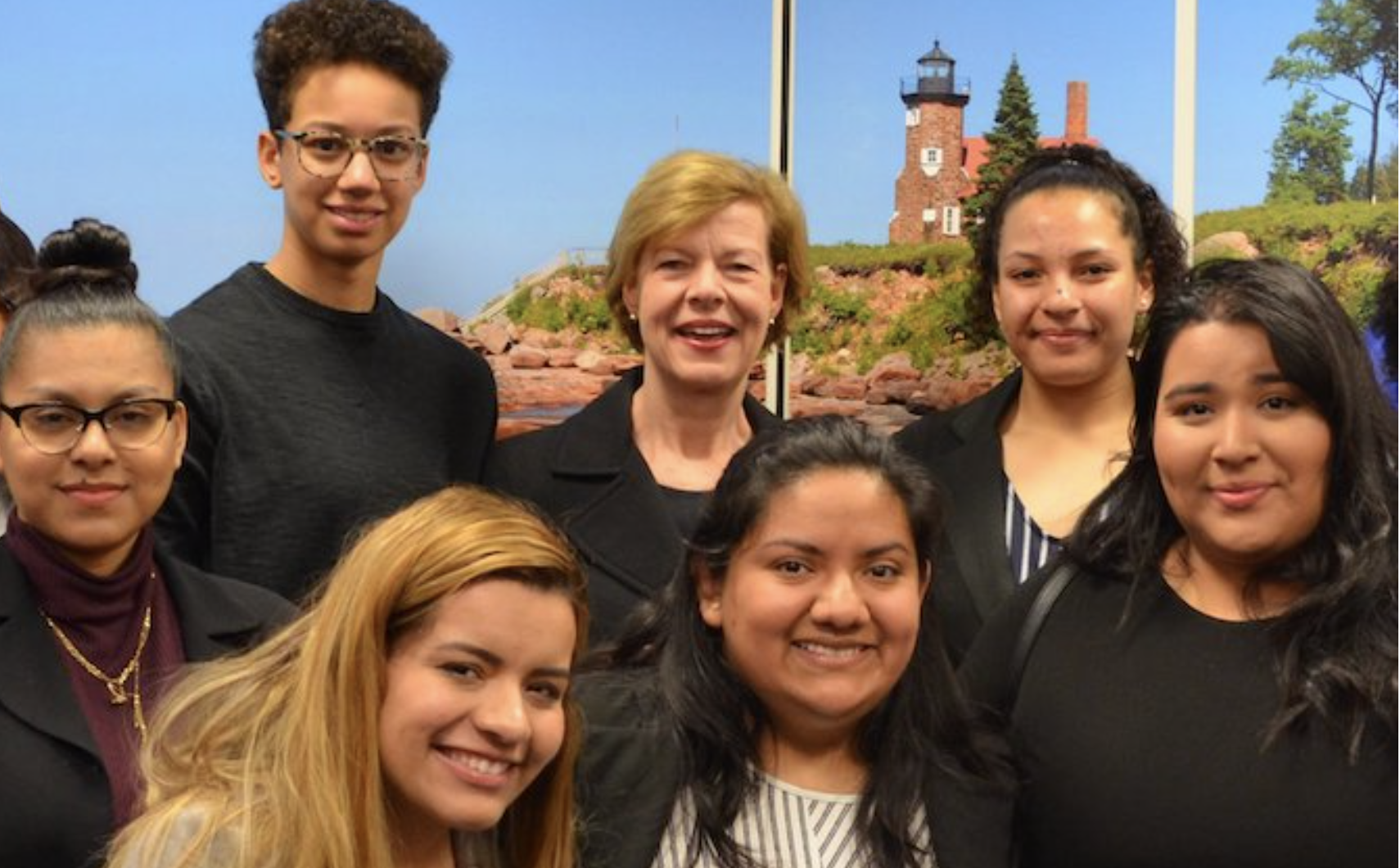 A group of smiling students from Senator Baldwin's summer internship program 