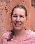 Photo of Sabine Pellett in pink shirt over clay background