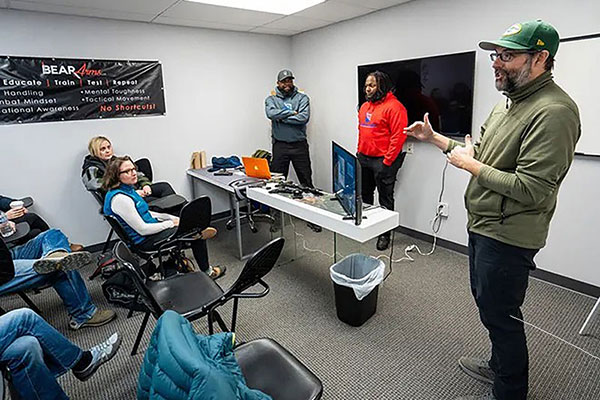 Dr. James Bigham (foreground) works with experts at Bear Arms in Mequon to teach a firearm injury prevention course to health care professionals.