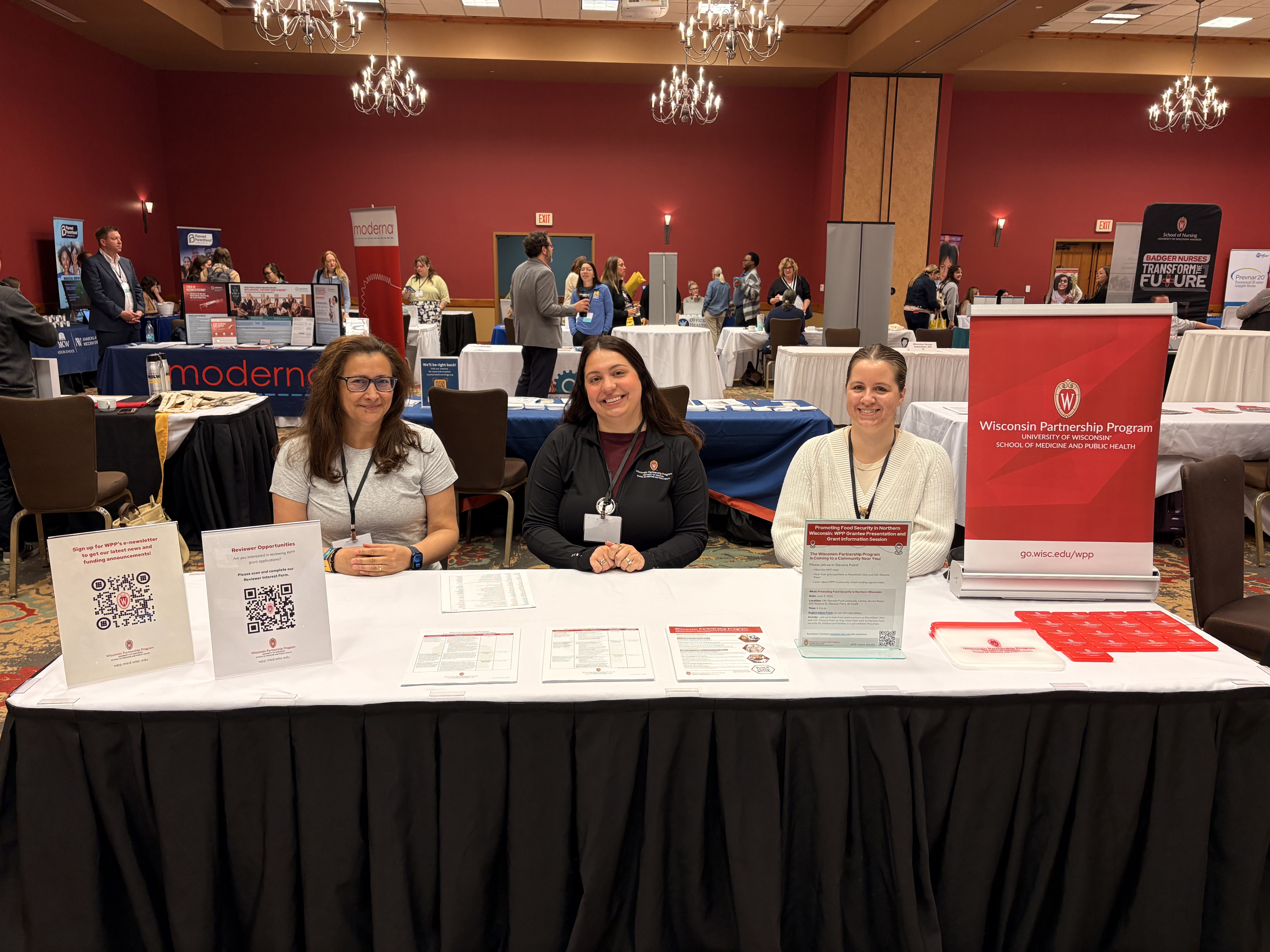 WPP staff members sit at conference booth