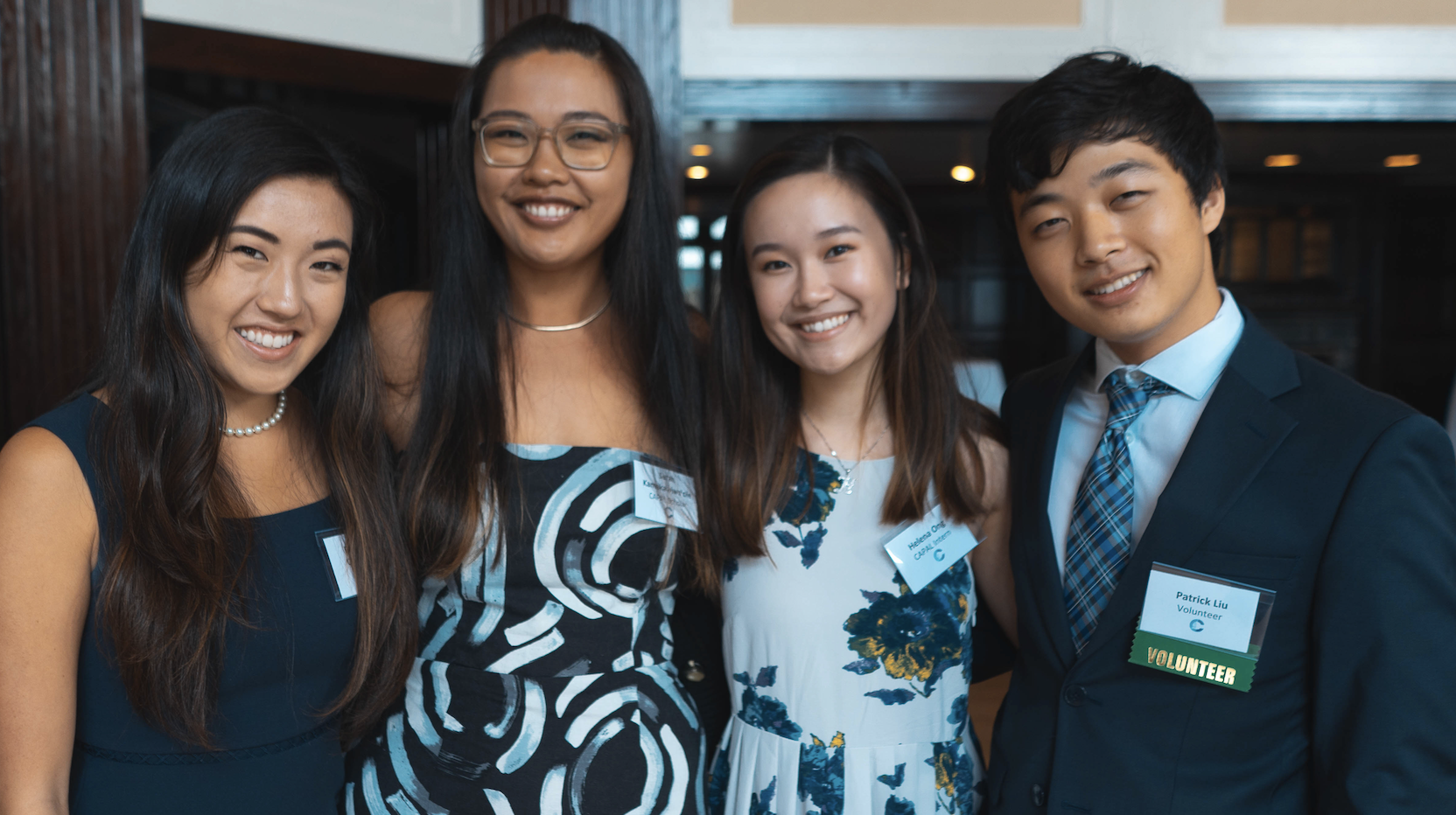 Four students standing and smiling, representing participants of the Conference on Asian Pacific American Leadership Paid Public Service Internships.