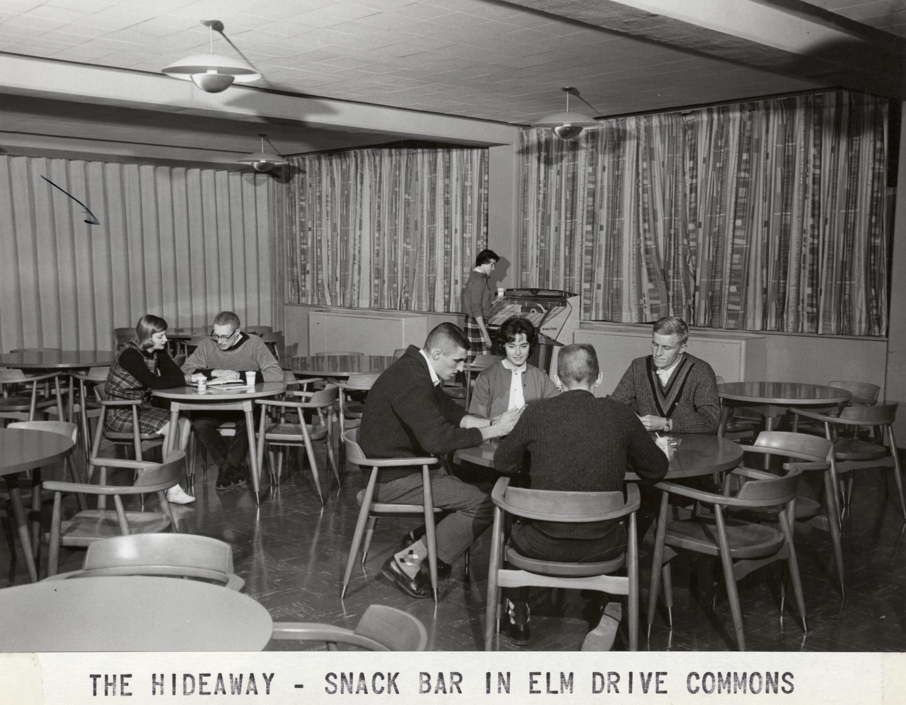 Students lounging in the Hideaway Snack Bar in Elm Drive Commons