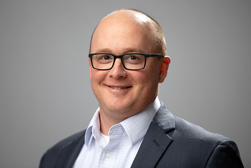 Photo of department chair, Dr. Paul Koch, a white male in a light button down shirt and darker jacket