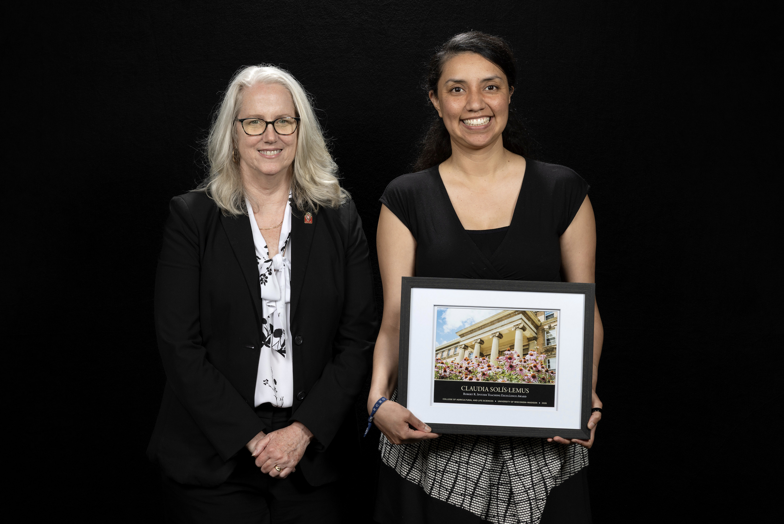 Claudia Solis Lemus receives an award from Dean Glenda Gillaspy.