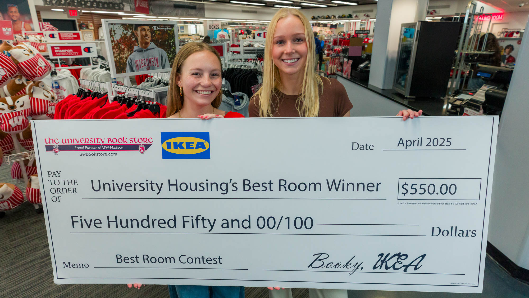 Avery & Katie pose with a big check in the University Book Store on State Street