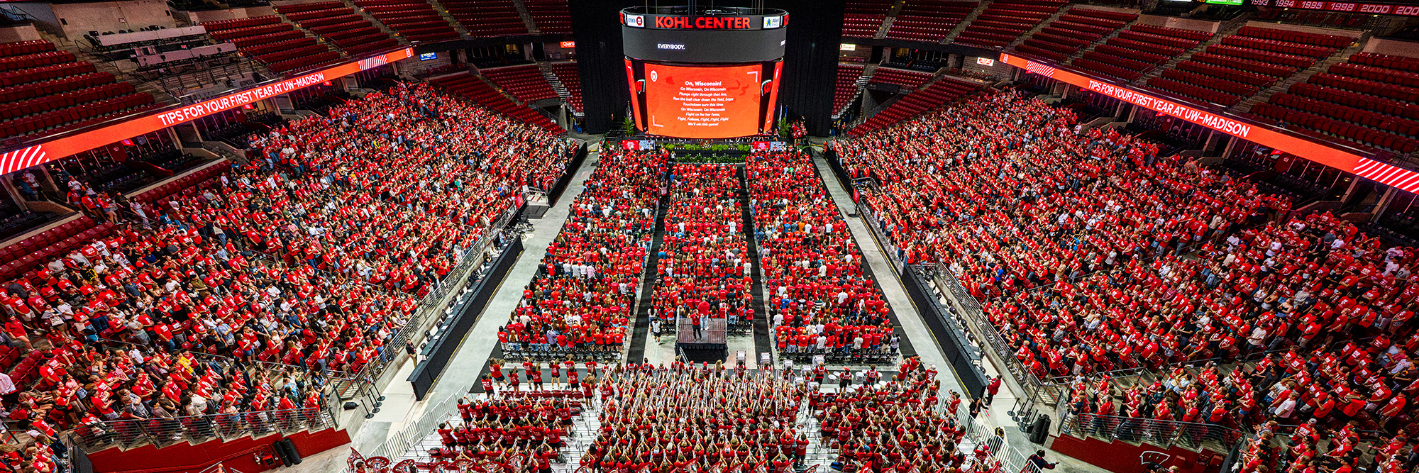 A wide photo of students filling the Kohl Center at New Student Convocation